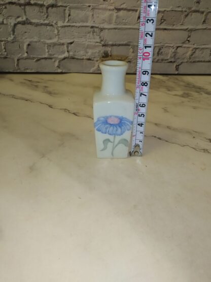Valge keraamiline vaas, sinine lill